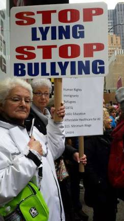 Onward: 400,000 take to the streets Violet Smith, left, and Christine McGregor at the march Saturday. Photo: Charmaine P. Rice