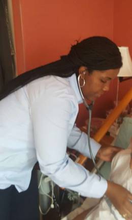 putting her heart into care Visiting Nurse Service of New Yor hospice nurse Claudia Paul checks in on a patient. Photo courtesy VNSNY