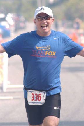 A Superhero, Raising Awareness Bret Parker during the run portion of a triathlon in 2014. Courtesy of Bret Parker