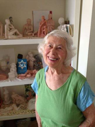 Esther Lazarson at home in her Upper West Side apartment, in front of her original sculptures.
