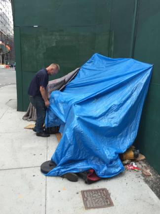 living in a valley of glass Larry Martin, who has lived for two years in a makeshift tent on West 31st Street near 10th Avenue, in the shadow of the ongoing Hudson Yards megadevelopment project. Photo: Isidro Camacho