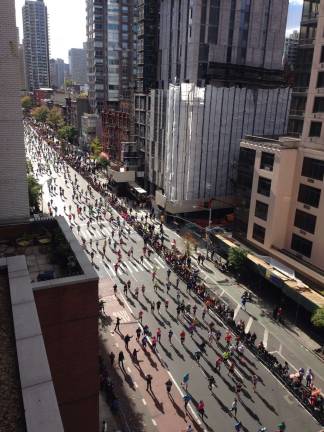Road Trip! The New York City Marathon field running up First Avenue in Yorkville shortly after 1 p.m. Sunday. More than 50,000 people from 120 countries participated. Photo: Rick Sayers