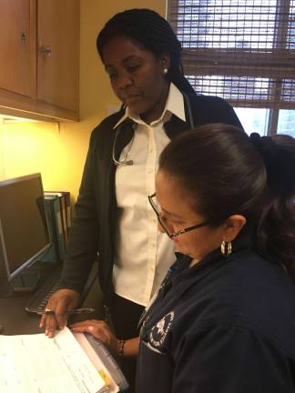 putting her heart into care Claudia Paul, standing. Photo: Bernard White, Visiting Nurse Service of New York