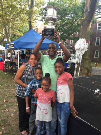 Dishing it out at the vendys Godshelter and Bisola Oluwalogbon, along with their three children, with the the Vendy Cup, the top honor in the annual street food competition put on by the Street Vendor Project. Photo: Carson Kessler