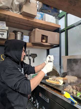 ‘tis the season Freddy Rojas preparing a cheesesteak at Truffleist in Bryant Park. Photo: Liz Hardaway