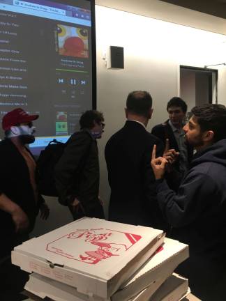 COLLEGE REPUBLICANS STAKE CLAIM An anti-Trump dissenter, right, flips off conservative blogger Lucian Wintrich, middle, as Wintrich leaves a March 23 talk at New York University. Photo: Claire Wang