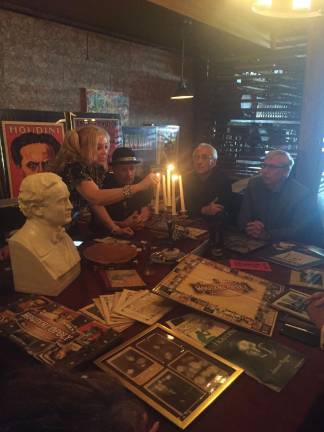 A séance at Houdini’s home Dorothy Dietrich lights the candelabra before leading the séance with a few moments of silence. Photo: Carson Kessler