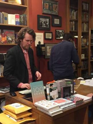 Bookstore manager Thomas Talbot was on duty during the closing party at Crawford Doyle Booksellers. Photo: Christopher Moore