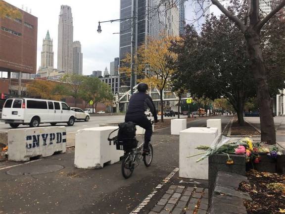 Hard lessons of vehicle attack A cyclist passes newly installed concrete barriers on the Hudson River Park Bikeway in Lower Manhattan, near the site of the Oct. 31 vehicle attack that killed eight people. Photo: Michael Garofalo