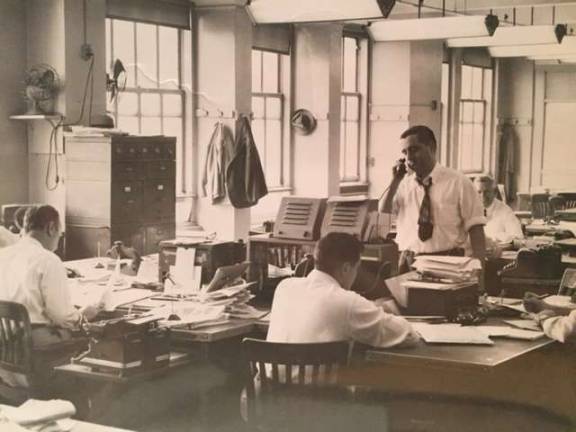 ‘TOO TOUGH TO DIE’ The Daily News's City Room in the early 1950s. Standing is longtime press agent, publicist and political fixer Morty Matz, then an assistant picture assignment editor at the paper. Photo: Collection of Morty Matz