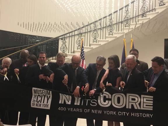 Biting into the big apple's core Museum of the City of New York administrators and elected officials at a Tuesday morning ribbon cutting of a permanent exhibit, “New York at its Core,” that will be open for 32 hours straight beginning Saturday morning. Photo: Madeleine Thompson