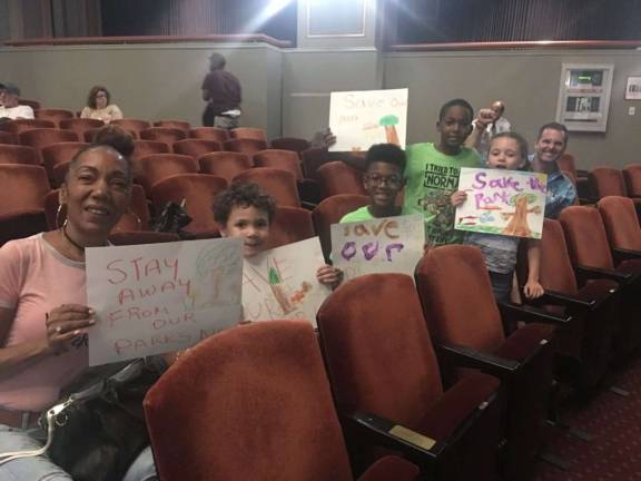A new anti-gilder center candidate Isabella Duncan (left) took her grandchildren and son-in-law Jeff Wright (right) to a hearing last week to oppose the planned Gilder Center for Science, Education and Innovation. Photo: Madeleine Thompson  