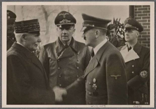 MONUMENTAL BATTLE RAGES OVER MONUMENTS The infamous 1940 photo of Marshal Philippe Petain, the French hero of the Battle of Verdun in World War I who became the leader of the collaborationist Vichy France government following the German invasion of World War II, shown shaking hands with Adolf Hitler. Mayor Bill de Blasio has suggested removing a marker on lower Broadway that commemorates the ticker tape parade that was held in 1931 to honor Petain. Photo: New York Public Library collection