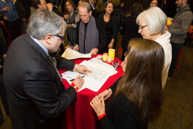 45 years and counting event honors our town, east side businesses Illustrator John S. Winkleman signing copies of his drawings.