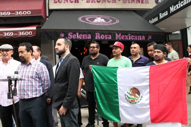 name of the rose amended Sammy Musovic (left, with cap), the owner of Selena Rosa on Second Avenue, and Armando Martado (at mic), discuss the settlement of a dispute about the restaurant's name. Photo: Alexandra Zuccaro