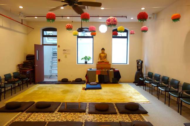 GOOD KARMA ON 64TH STREET One of several interior spaces at the Zen Buddhist Temple on East 63rd Street – under the lotus lanterns, in front of the central icon of the Buddha – that followers use for meditation and chanting. The practice of meditating, Buddhists believe, is the direct path to freedom and enlightenment. Photo: Ben Henry / Zen Buddhist Temple