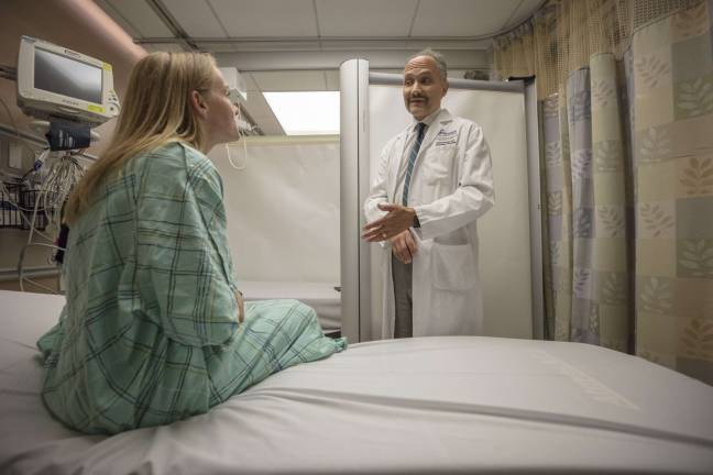 saving lives every day Dr. Rob Femia, chair of the Ronald O. Perelman Department of Emergency Medicine at NYU Langone Health, discusses treatment with a patient in the emergency room. Photo: Andrew Neary