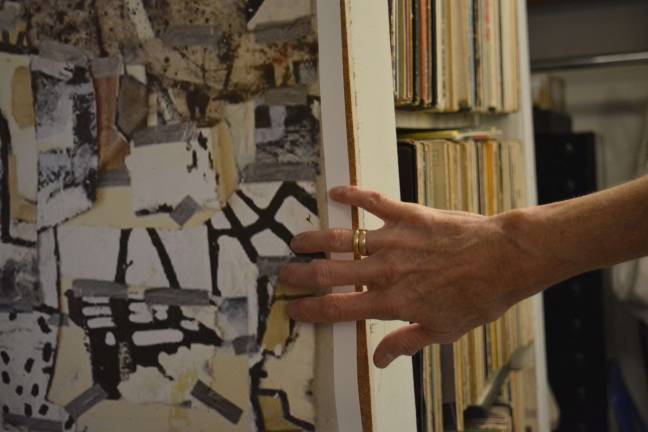 recycling beauty Esla Cusick traces the dark lines of masking tape in the picture she took of a student's artwork. Photo: Diamond Naga Siu