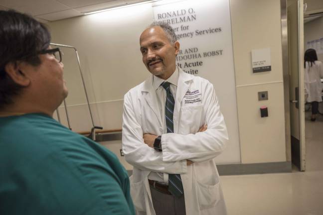 saving lives every day Dr. Rob Femia, chair of the Ronald O. Perelman Department of Emergency Medicine at NYU Langone Health, discusses a patient case with his colleague. Photo: Andrew Neary