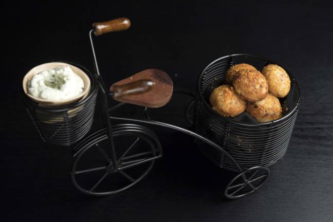 Not Your Neighborhood Indian Restaurant Corn paddu is served on a miniature bicycle. Photo: Evan Sung