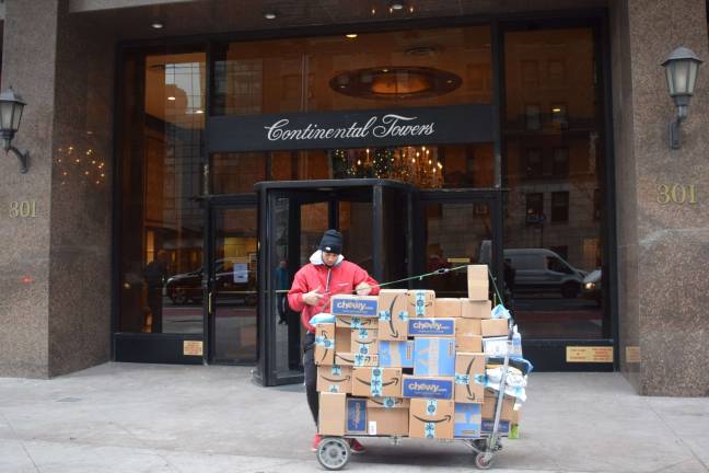 Holiday package boom Staff at residential buildings feel the brunt of the online retail surge in December, fielding increased package deliveries. Photo: Michael Garofalo