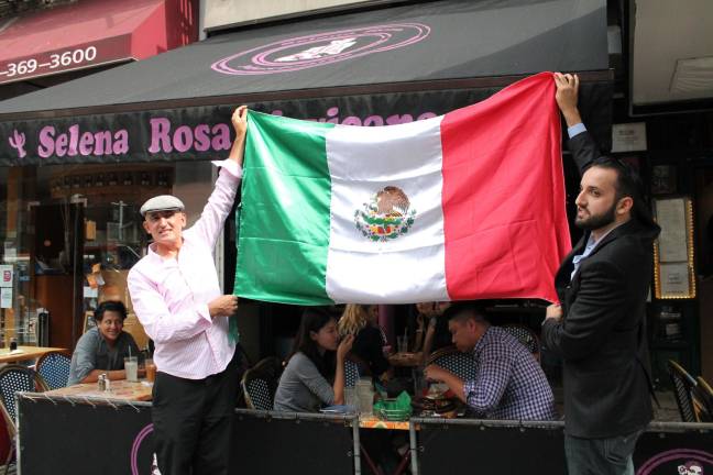 name of the rose amended Sammy Musovic (left), the owner of Selena Rosa on Second Avenue, raises a Mexican flag to commemorate that country's independence day as well as a settlement of a dispute about the restaurant's name. Photo: Alexandra Zuccaro
