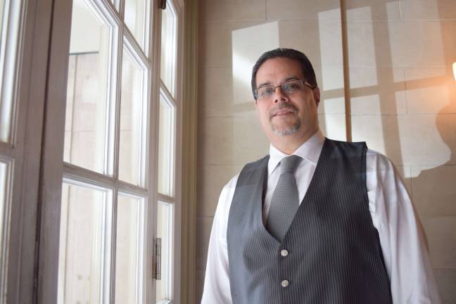 when residents are like family Edwin Peralta in front of the huge windows of the Studio Building. Photo: Genia Gould