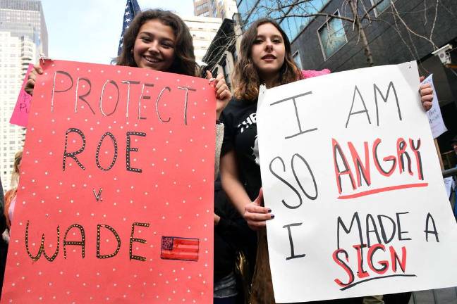 Marching Millennials A couple of the participants and their signs at the Women's March on New York City on Jan. 21. Photo: Alicia Alonso.