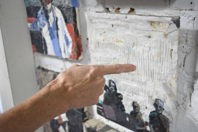 recycling beauty Hell's Kitchen Painters teacher Esla Cusick points at cardboard ridges that were highlighted when mixed with cloth and glue. She made this artwork using her over 90 year old student's father-in-law's handkerchief from Germany. Photo: Diamond Naga Siu