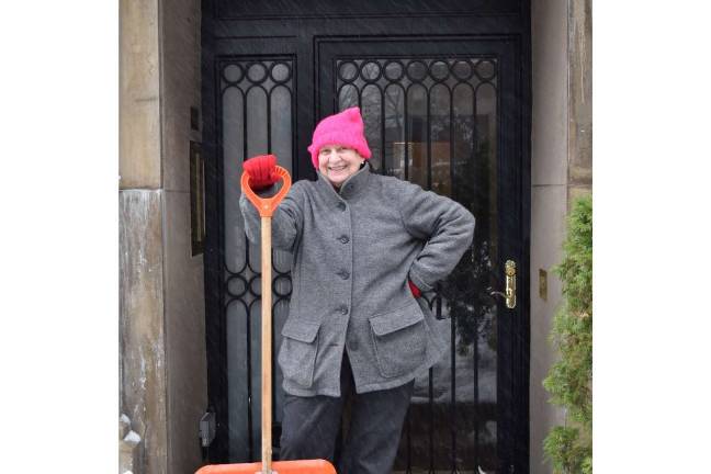 The Blizzard that wasn’t Kathryn Buck took a break from clearing snow from the walkway in front of her West 23 Street building on Tuesday morning.  Photo: Genia Gould