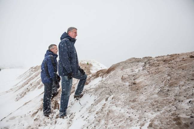 CAPTURING the mayor Mayor Bill de Blasio stands with the director of the Mayor's Office of Recovery and Resiliency, Daniel Zarrilli, on a temporary sand berm which built to protect against storm surge flooding on the beach at Coney Island during a major snowstorm in January 2016. Photo: Michael Appleton/Mayoral Photography Office
