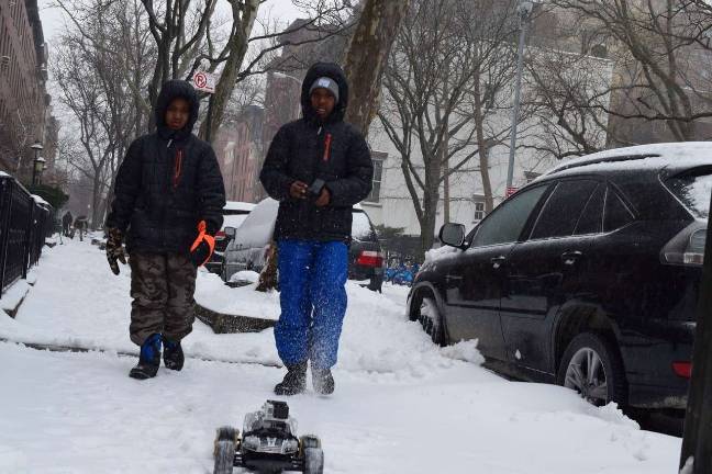 The Blizzard that wasn’t The icy snow made for rough terrain on which to operate a remote control RV, but Lenny, 9, left, and his brother Kenzo, 12, found a spot on West 22nd Street Tuesday morning. Photo: Genia Gould