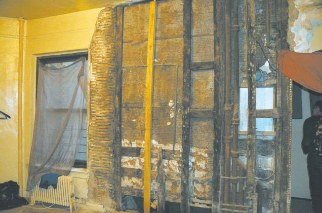 The wall separating Jennifer Sinclair's living room and bathroom at 74 West 103rd Street.