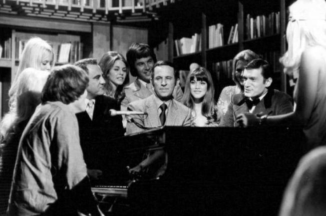 HUGH HEFNER’S NEW YORK A 1970 press photo for the syndicated TV show "Playboy After Dark," which was in taped in Los Angeles. Hugh Hefner (in tuxedo) is at far right, actor-comedian Don Adams, who played Maxwell Smart, also known as "Agent 86," in the comedy "Get Smart," is at center, and Playboy cover girl and longtime Hefner girlfriend Barbi Benton is seated between them. Photo: Playboy Enterprises, via Wikimedia Commons