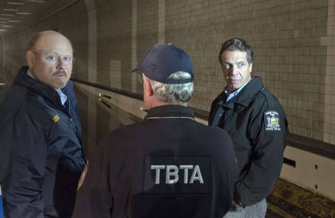 the big question MTA Chairman Joseph Lhota (left) with Gov. Andrew Cuomo (right) in the flooded Brooklyn Battery Tunnel, Oct. 30, 2012. Photo: MTA / Patrick Casahin