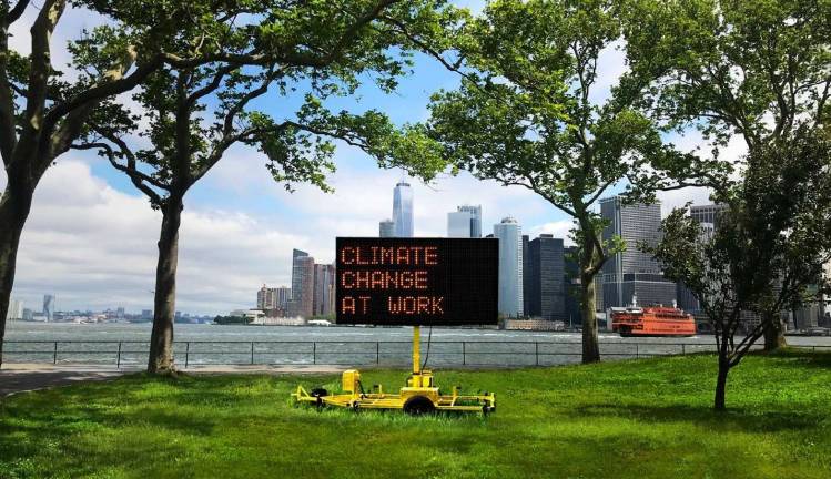 the big question “Climate Signals,” a public art installation by Justin Brice Guariglia, consists of solar-powered highway signs in parks across the city displaying messages about climate change. The exhibition, sponsored by the Climate Museum and the Mayor's Office of Climate Policy and Programs, is on display Sept. 1 to Nov. 6. Image courtesy of the Climate Museum.