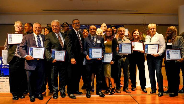 celebrating the building service worker award winners 32BJ President Hector Figueroa and Straus Media-Manhattan Publisher Jeanne Straus with the 2017 Building Service Award winners. Photo: Preston Ehrler/prestonehrler.com
