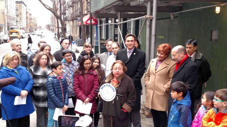 to give or not to give? State Senator Liz Krueger (first row, center, speaking) and City Council Member Ben Kallos (standing behind her, second row center) at a press conference in March announcing new supportive housing for families on East 91st Street between First and Second Avenues. The two East Side elected officials hold different views about whether residents should give money to homeless panhandlers or offer help in other ways or both. Photo: Courtesy of Senator Liz Krueger’s office
