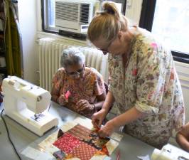 Liz Curtin (right) helps student during a sewing class she teaches at the Carter Burden/Leonard Covello Senior Center. Photo: Christina Cardona