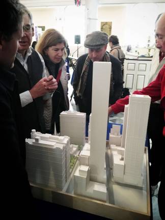 Attendees at a recent community charrette in St. Paul&#x2019;s Chapel look at a model of Trinity Church&#x2019;s planned parish building. Photo: Emily Towner