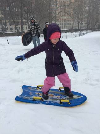 Upper West Sider Matilda Surla, 7, took advantage of the snow day by snowboarding down hills in Central Park. Photo: Michael Garofalo