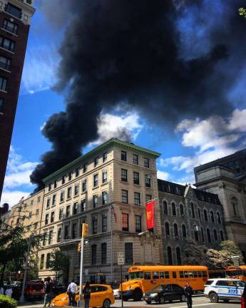 A fire started on the roof of a building at St. Ignatius Loyola Parish on East 83rd Street on Tues., May 9. Photo: Lawrence Sullivan