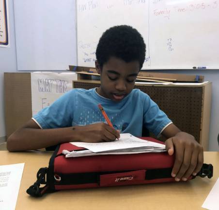 Phillip Raymond, 13, an eighth grade student participating in Breakthrough New York. His favorite electives are digital music, which is about music production, and chess. Photo: Christina Cardona