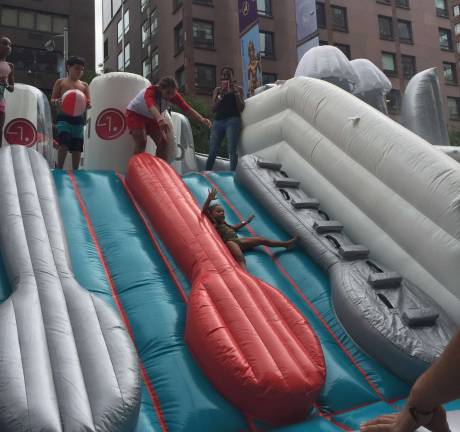 A child rides down between inflatable cutlery on the LG Quadwash waterpark slide.&#xa0;Photo: Bryse Ciallella