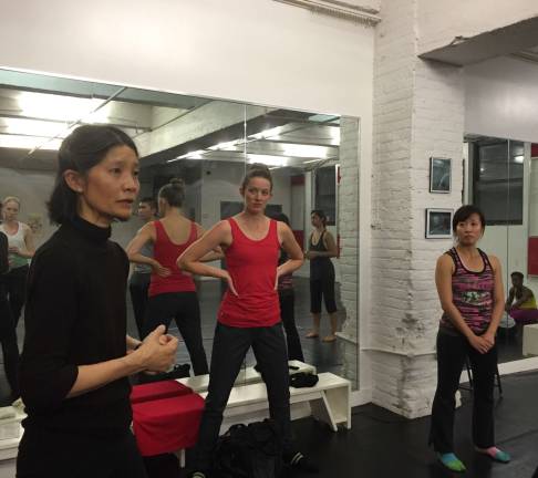 Dian Dong, left, instructing her dance students.