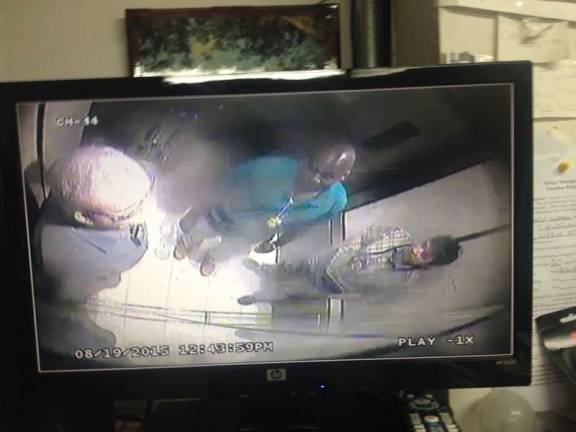 Surveillance images obtained by the Spirit show three unknown men suspected of impersonating police officers in an elevator at 50 West 93rd St.