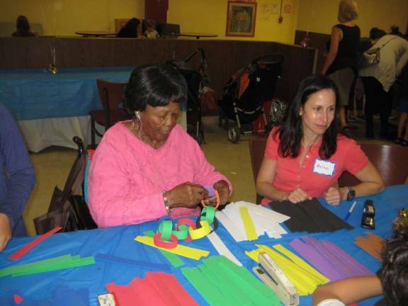 Seniors and Kids Decorate Sukkah Together
