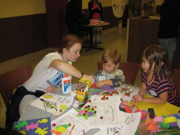 Seniors and Kids Decorate Sukkah Together