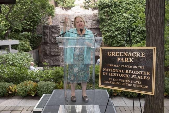 State Senator Liz Krueger stands by a plaque at Greenacre Park on East 51st Street at ceremonies earlier this month to mark the naming of the 47-year-old oasis, a gift of the Rockefeller family, to the National Register of Historic Places. Photo courtesy of Greenacre Foundation / Howard Jay Heyman
