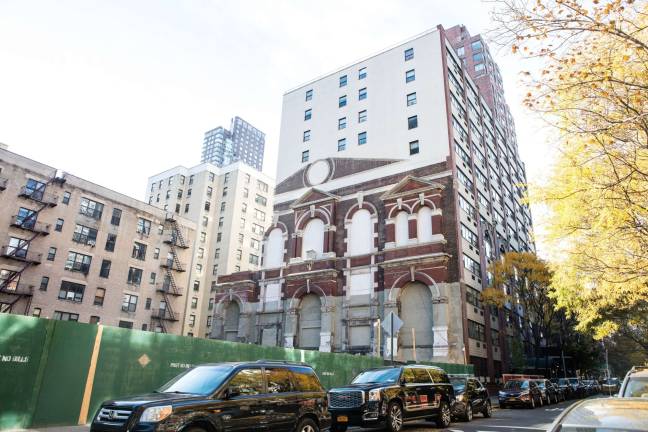 Vestige of an old Yorkville chapel, embedded into a neighboring building, stands sentinel over an empty lot where the Spence School is constructing a new athletic complex. When completed, the facade will no longer be visible. Photo: Sarah Greig Photography / FRIENDS of the Upper East Side Historic Districts